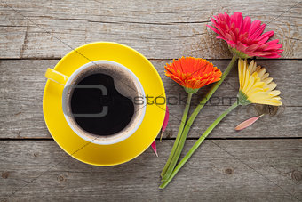 Cup of coffee and gerbera flowers