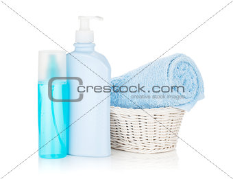 Cosmetics bottles and blue towel