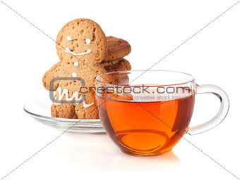 Glass cup of black tea with homemade cookies and gingerbread man