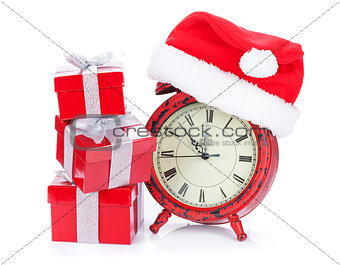 Christmas clock, gift boxes and santa hat