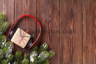 Christmas gift box with headphones and tree branch