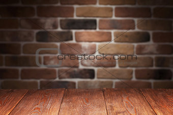Wooden table and brick wall