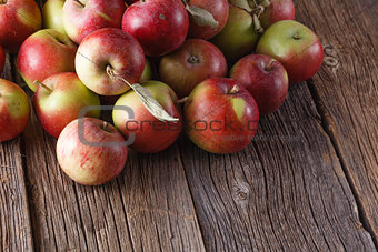Scattered apples on rustic wooden background