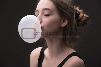 brown-haired girl with bubble of chewing gum