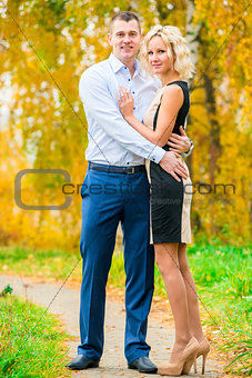 young beautiful couple posing in park