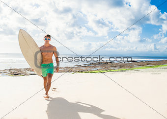 professional surfer holding a surf board