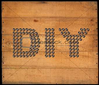 Diy Symbol - Screws on Wooden Background