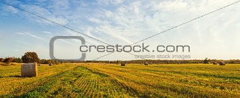 Panorama of scenic view of hay stacks at fall