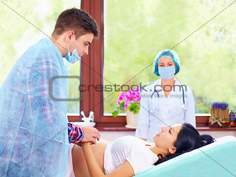 partner helps his wife during the childbirth