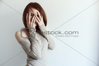 Beautiful grunge woman covering face with palm