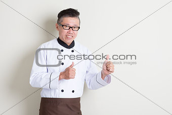 Mature Asian chef thumbs up