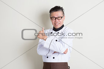 Mature Asian Chinese chef giving thumb up