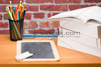 Desk with school supplies and slate