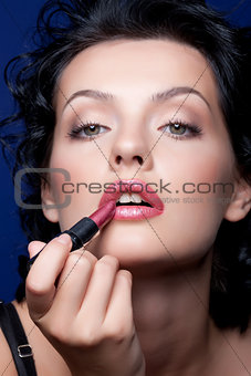 Young Woman Applying Cosmetics
