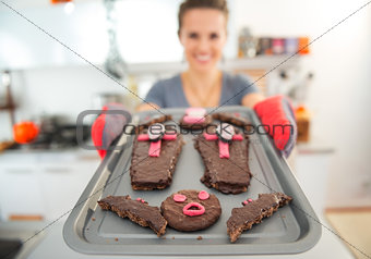 Closeup on tray with Halloween biscuits in hands of housewife