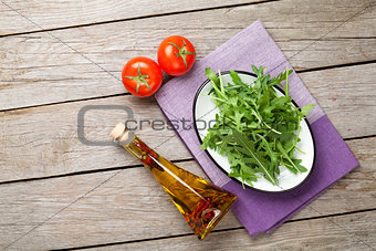 Arugula salad, tomatoes and olive oil bottle