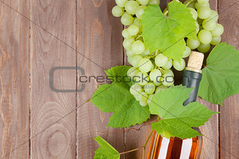Bunch of grapes and white wine bottle