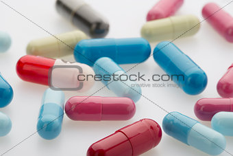 Colorful medicine capsules on white background