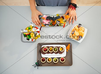 Woman preparing horribly halloween treats for party. Closeup