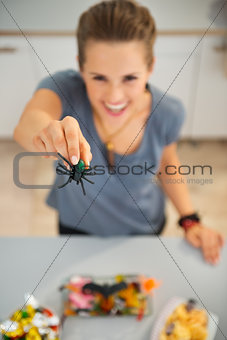 Closeup on spider toy in hand of woman preparing halloween treat