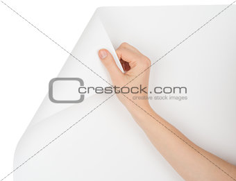 Humans hand turning upper left empty page corner