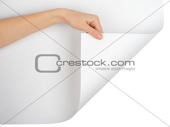 Womans hand turning empty page corner
