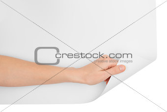 Womans hand turning bottom blank page corner