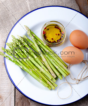 Fresh asparagus, olive oil and eggs .