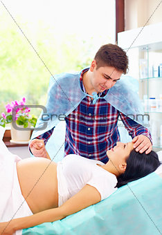 partner soothing pregnant woman during affiliate childbirth
