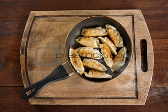 Asian meal fried dumpling in cooking pan