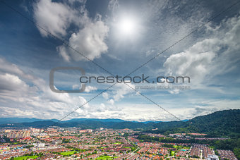 cityscape and mountains against blue sky