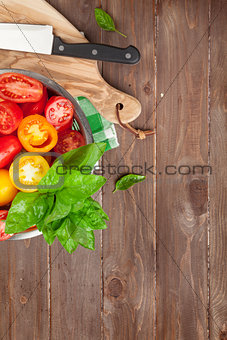 Fresh colorful tomatoes and basil in colander