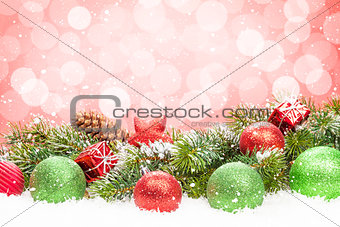 Christmas tree and bauble decor on snow