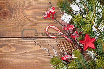 Christmas wooden background with snow fir tree and decor