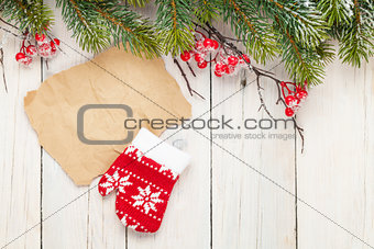 Christmas wooden background with fir tree and mitten decor