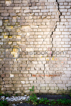 Old cracked white brick wall 