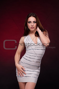 Beautiful woman in dress isolated on red