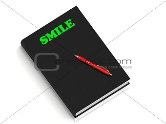 SMILE- inscription of green letters on black book 