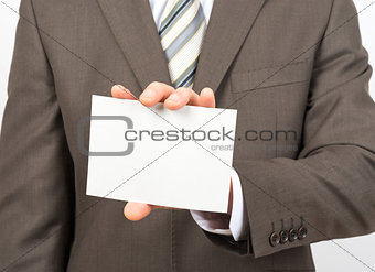Businessman holding empty sheet of paper