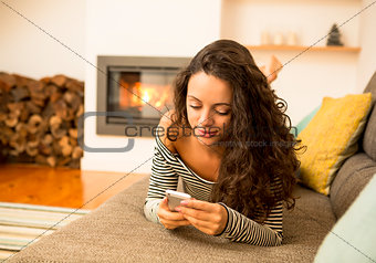 Woman with her cellphone at home