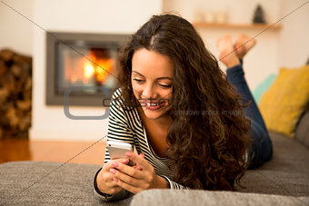 Woman with her cellphone at home