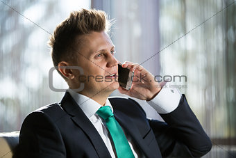 Stylish businessman talking to someone on the phone