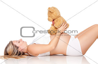 Pregnant woman with a cute teddy bear