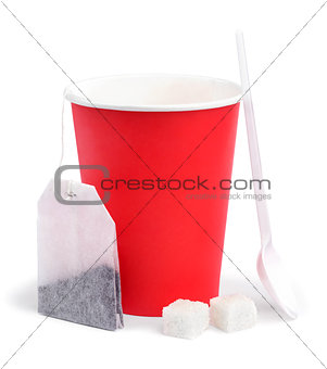 Paper cup, teabag, spoon and sugar.