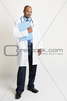 Mature Indian doctor holding medical report
