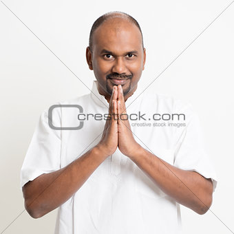 Mature casual business Indian man praying