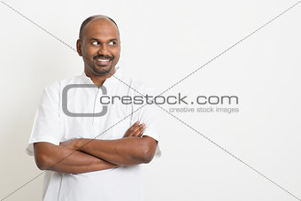 Mature Indian man looking side and smiling