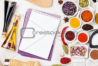 Various spices and condiments on white wooden background