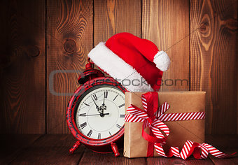 Christmas gift box, alarm clock and santa hat