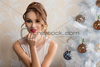 lovely girl with decorated xmas tree 